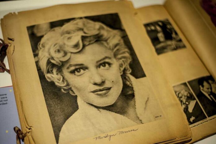 Black and white vintage photograph of a woman with curly hair, resembling Marilyn Monroe