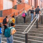 Group of students ascending outdoor stairs on a campus