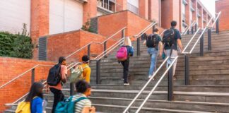 Group of students ascending outdoor stairs on a campus