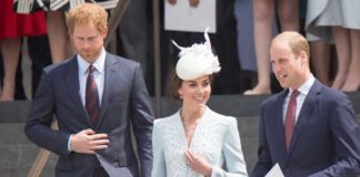 Members of the royal family at an outdoor event, dressed in formal attire
