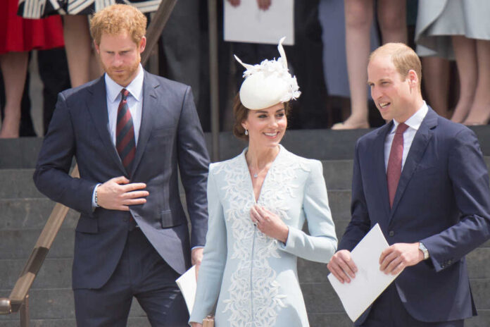 Members of the royal family at an outdoor event, dressed in formal attire