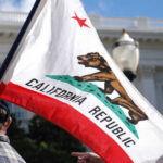 California state flag being held up at an outdoor event