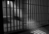 Sunlight streaming through prison cell bars.
