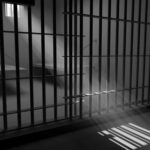 Sunlight streaming through prison cell bars.