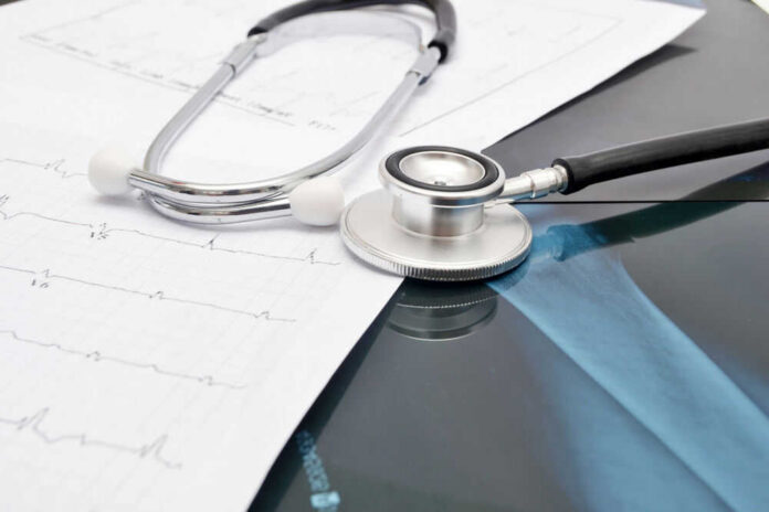 52601597 Stethoscope on medical charts and X-ray image.