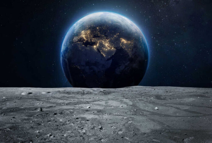 Earth rising above the moon’s barren surface in deep space