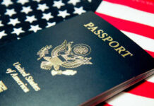 An American passport resting on a background of the U.S. flag