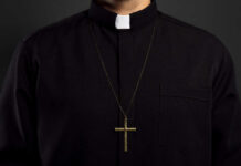 Tourist Trap: Rome’s Faux Clerical Calendar! Clerical shirt with a cross necklace against a dark background