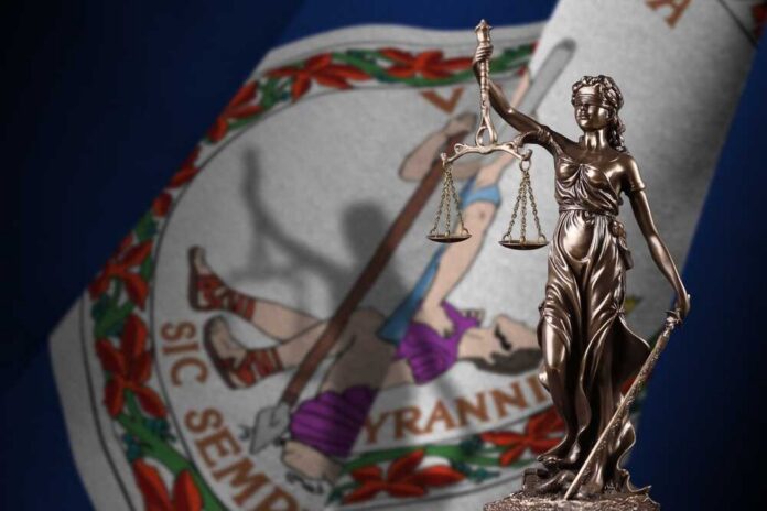 Bronze statue of Lady Justice in front of the Virginia state flag