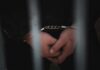 Filipino Sailor CAUGHT With 500 Pounds of Cocaine Close-up of handcuffed hands behind bars