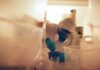 Scientist in protective gear mixing substance in a lab