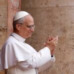 Pope clapping and smiling during a public appearance