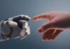 Shocking: Chinese Robots Steal American Crowds A robotic hand reaching out to touch a human hand
