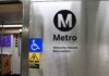 Metro sign with accessibility symbols and bilingual welcome message