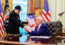 Trump’s Beijing Gamble: Corporate Titans Invited Two men shaking hands in the Oval Office during a meeting