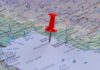 A red pushpin placed on a map indicating a specific location