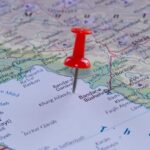 A red pushpin placed on a map indicating a specific location