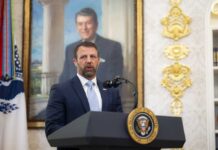 ICE Busts ‘Hunger Strike’ Lie — Detainees Live Better Than Americans Empty prison corridor with metal cell doors visible