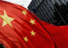 Xi’s Shocking Strategy: Is America Cornered? Close-up of the Chinese flag waving in the wind