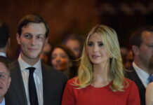 Two well-dressed people at an indoor event