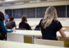 California Colleges’ STRANGE Bill: Deportees Teaching? Students seated in a classroom listening to a teacher