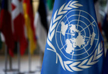 United Nations flag with world map emblem displayed