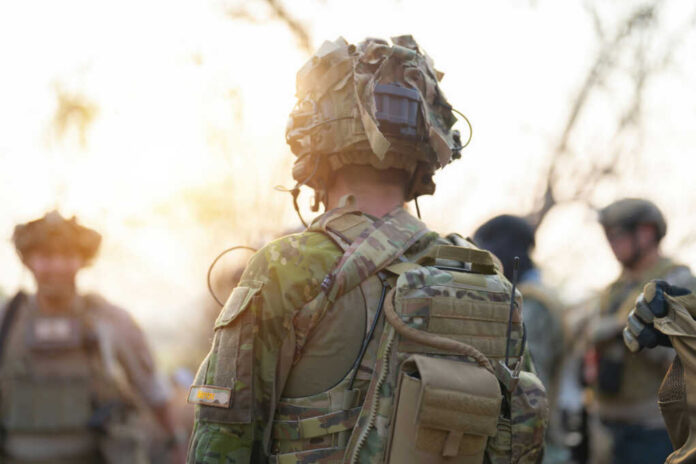 us-army-marine-corps-soldier2278749475jpg Soldier in camouflage gear with helmet and radio backpack