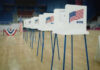Noncitizen Vote Hunt Ignites State Showdown Voting booths lined up in a gymnasium.