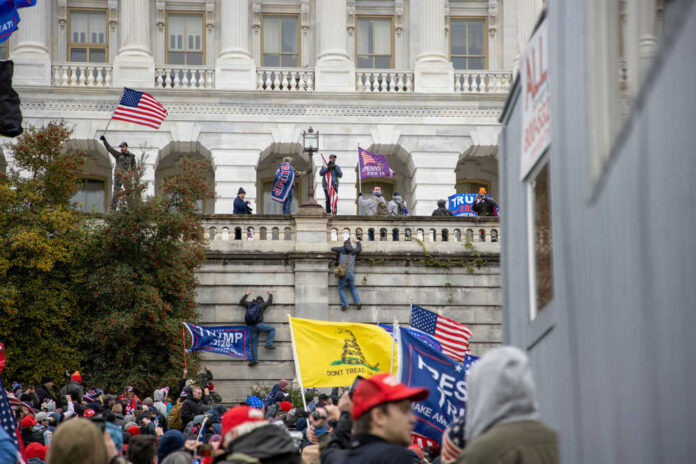 Crowd with flags at U.S. Capitol building.