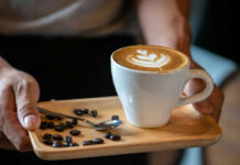 Public Shaming Backfires — Civil Rights Heat Latte with latte art on a wooden tray with coffee beans and a spoon