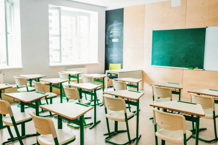 classroom207646682 Empty classroom with desks facing a chalkboard