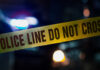 Police tape with do not cross message at night