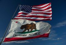 Federal Cash Floods California Immigrant Households American and California flags waving against a blue sky
