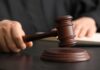 Judge Freezes Murder Case in ‘Trump House’ Killing A judge's hand holding a gavel above a wooden block