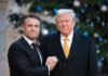 Economic War Plans Quietly Advance Two political leaders shaking hands in front of a decorated backdrop