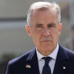Carney’s Ukraine Gamble Sparks Ethics Uproar A man in formal attire with a serious expression outdoors