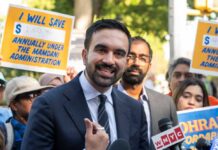 Abolish ICE? NYC Mayor Escalates A man speaking at a rally with supporters holding protest signs