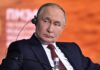 Blackmail Playbook: Moscow Tests Washington man in black overcoat and tie at a formal event