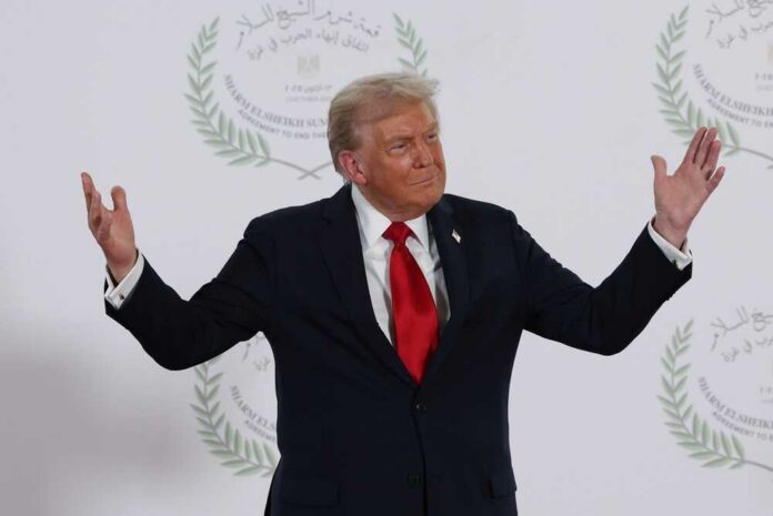 A political figure gesturing with hands during a public appearance