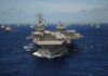 Steel Tariffs Blow Up Warship Plans Aircraft carrier leads a naval fleet at sea
