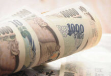 Yen Trap Looms — Hedge Funds Overexposed Stack of rolled Japanese yen banknotes.