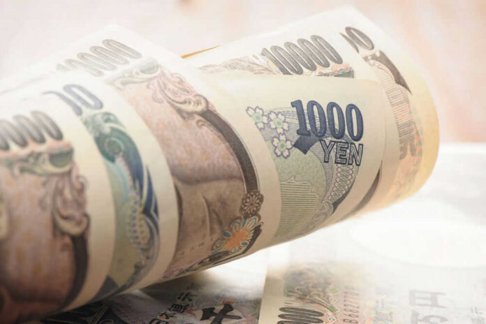 japan76328551 Stack of rolled Japanese yen banknotes.
