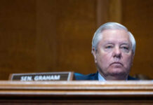 Shock Exit Triggers High-Stakes Senate Scramble Man sitting at a desk with nameplate Sen Graham