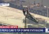 Empire State Breach Sparks Felony Bombshell Two people climb to the top of Empire State Building spire, unfurl banner