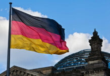 Missile Shield EXPANDS: Berlin Goes Exoatmospheric German flag waving against a blue sky near a historic building