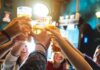 Group toasting with beer glasses in a pub