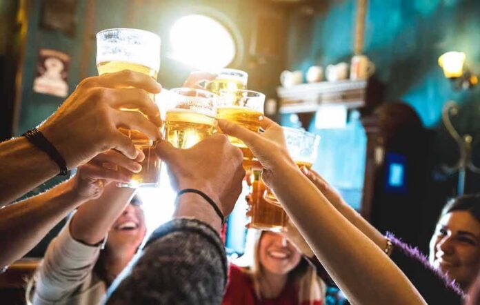 Group toasting with beer glasses in a pub