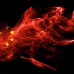 Chinese flag in red smoke on black background