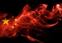 Chinese flag in red smoke on black background