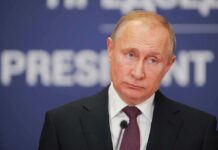 Kremlin Meltdown Over Seoul–NATO Link man in suit at podium with microphone